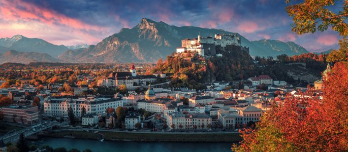 Colorful evening cityscape. Panoramic view on historic city of Salzburg with famous Hohensalzburg Fortress. Wonderful autumn landscape with picturesque sky. Softlight effect. Salzburger Land, Austria